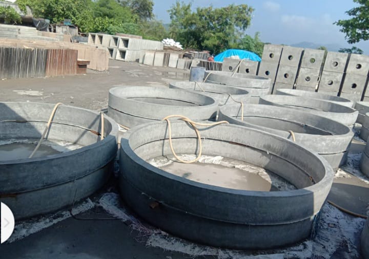 RCC Concrete Covers in Bulk, Stack of RCC concrete cover slabs stored in bulk for drainage use, Bulk quantity of reinforced concrete covers with ventilation slots, Multiple RCC concrete drain covers arranged for bulk supply, Precast RCC covers stored in large quantities at construction site